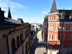 Street view from a high vantage point looking at red brick building bathed in sunlight