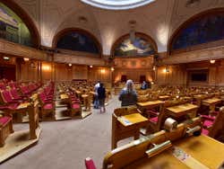 Red wooden seats inside the Second Chamber