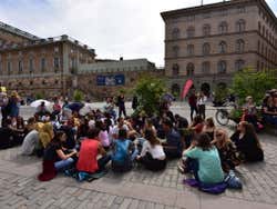 A group of people sit for a protest against climate change