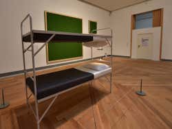 A bunk bed with the top bed upside down
